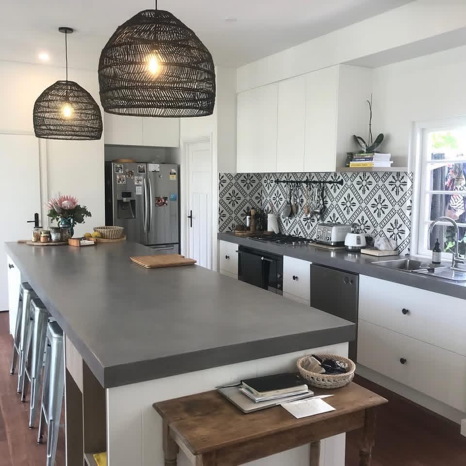 Kitchen island: A broad grey surface within a kitchen setting.