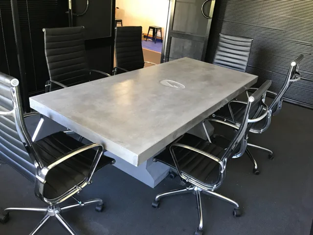 Meeting table: A rectangular grey table with a central cable opening.