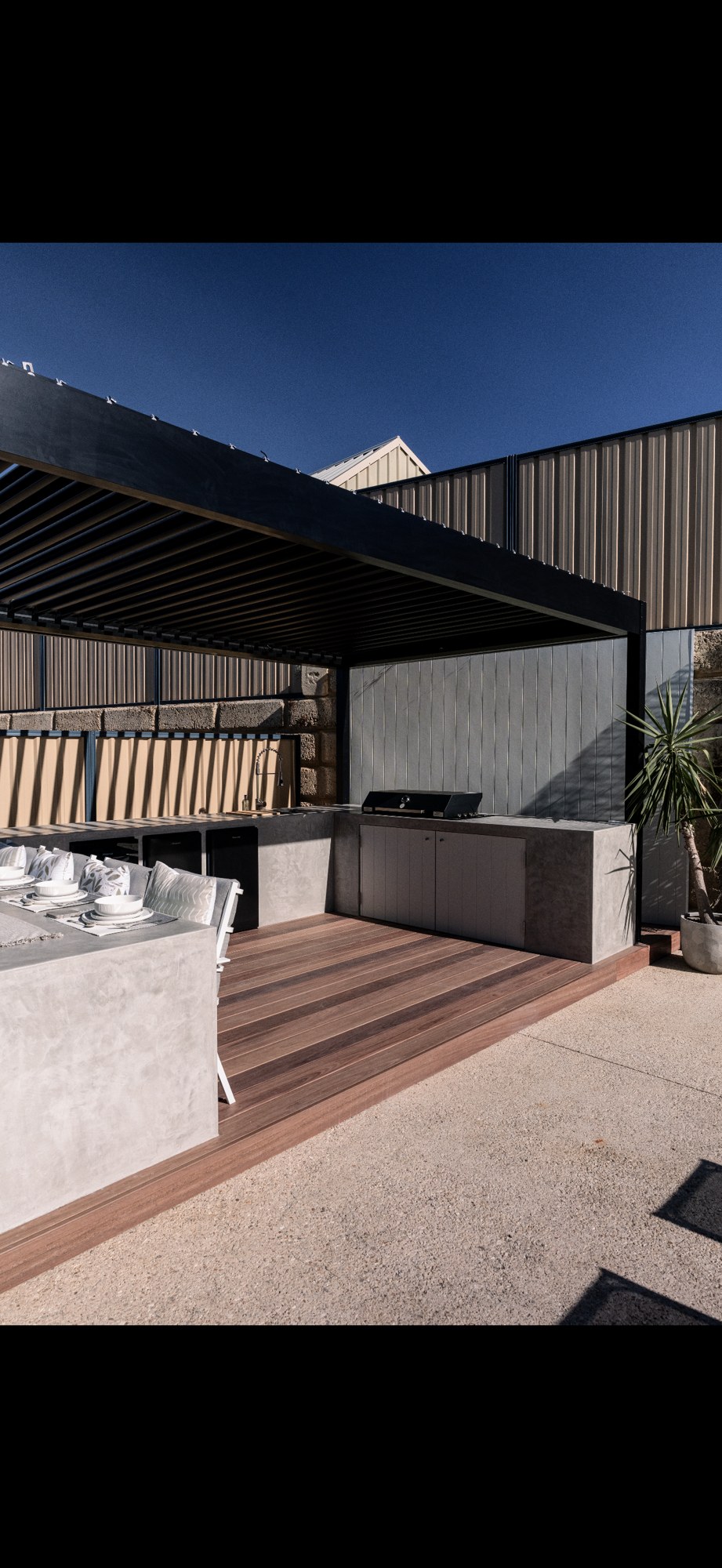 Outdoor entertaining space: An outdoor setting with dining and barbecue surfaces.